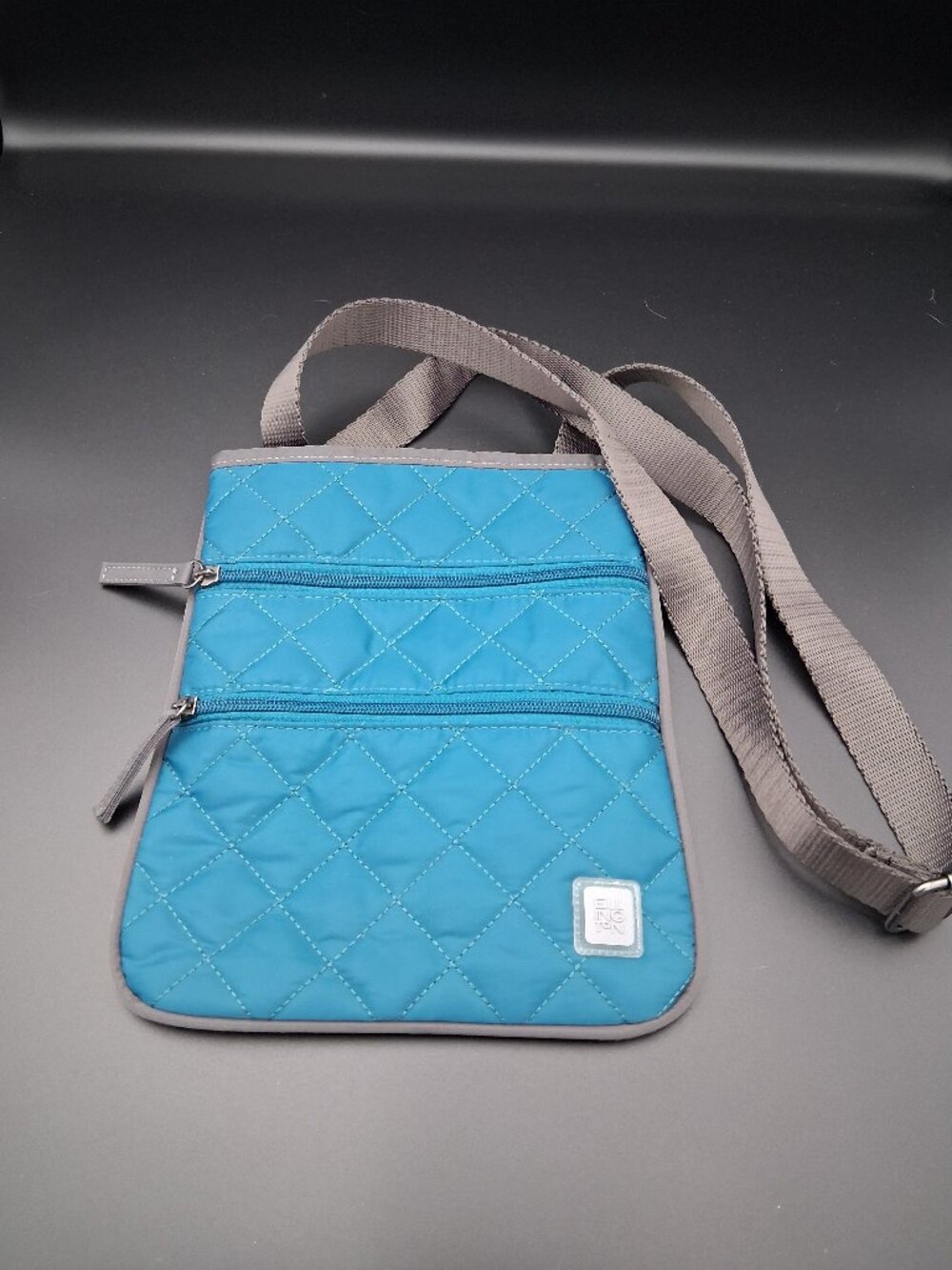 Ellington Teal Quilted Crossbody Bag with Two Front Zip Pockets. Casual style.